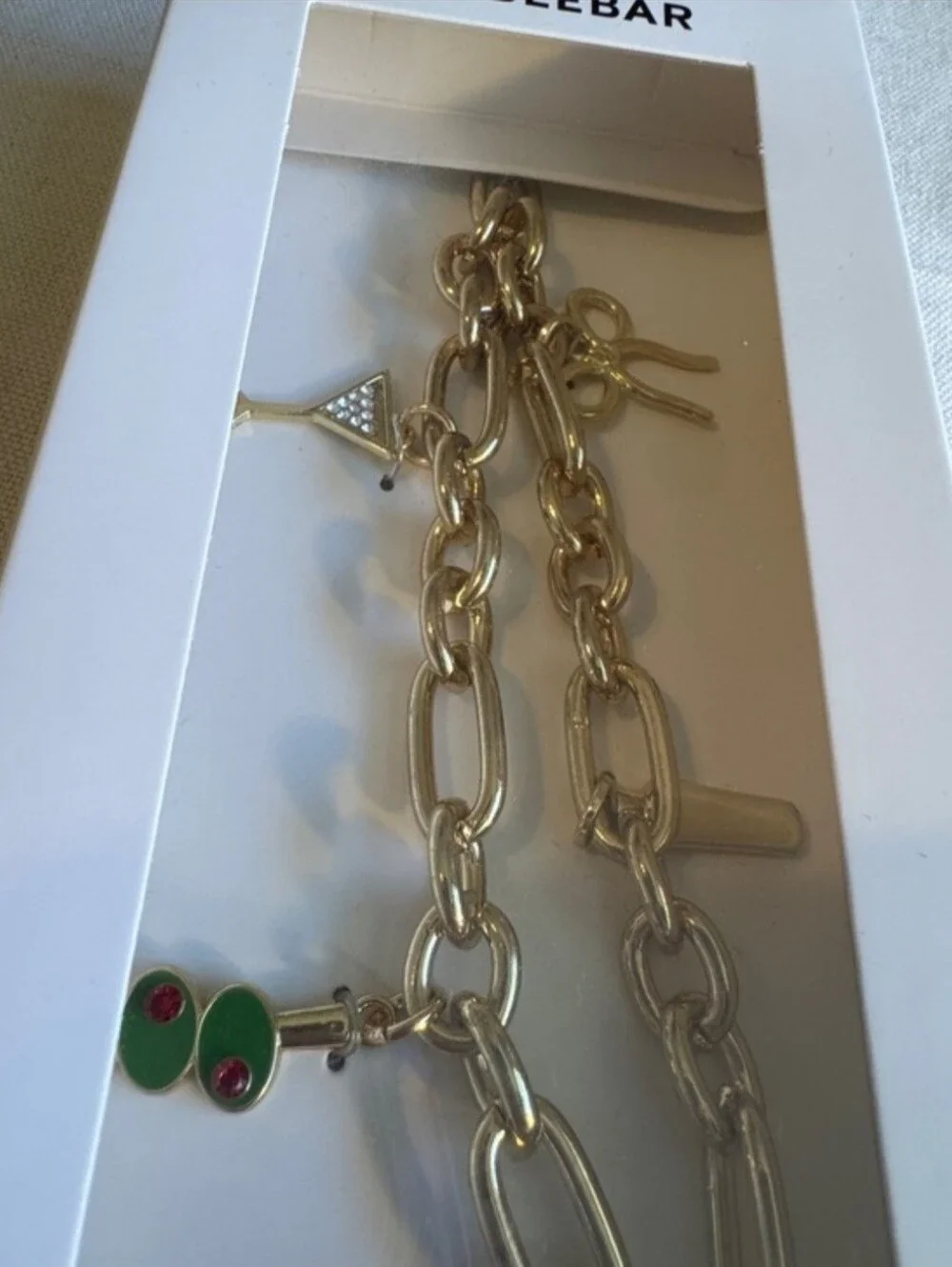 BaubleBar phone charm wristlet gold-tone chain Martini-themed charms New